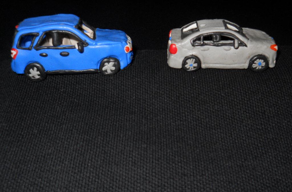 He spends hours concentrated in molding and bending average clay into these little vehicles.